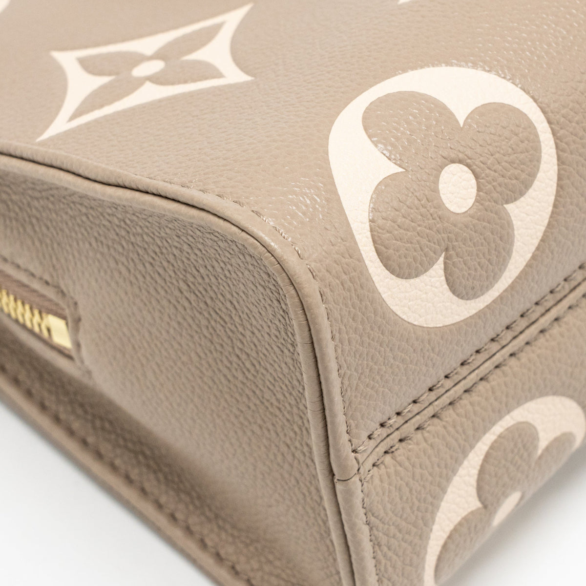 louis-vuitton-onthego-east-west-monogram-empreinte-leather-dove-cream-ghw-copy