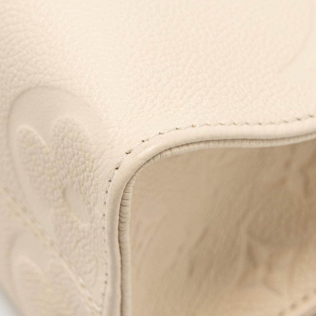 louis-vuitton-onthego-pm-monogram-empreinte-leather-creme-ghw